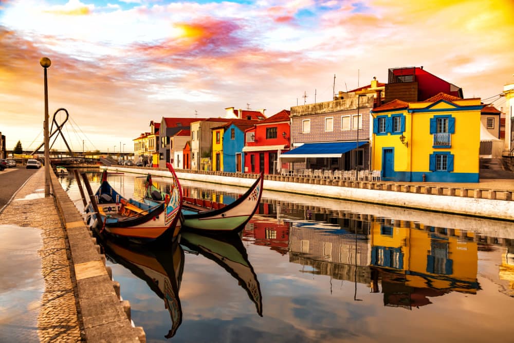 Traditional colorful Moliceiro boats docked in the water canal