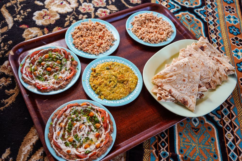 Traditional Omani food served on a carpet in restaurants