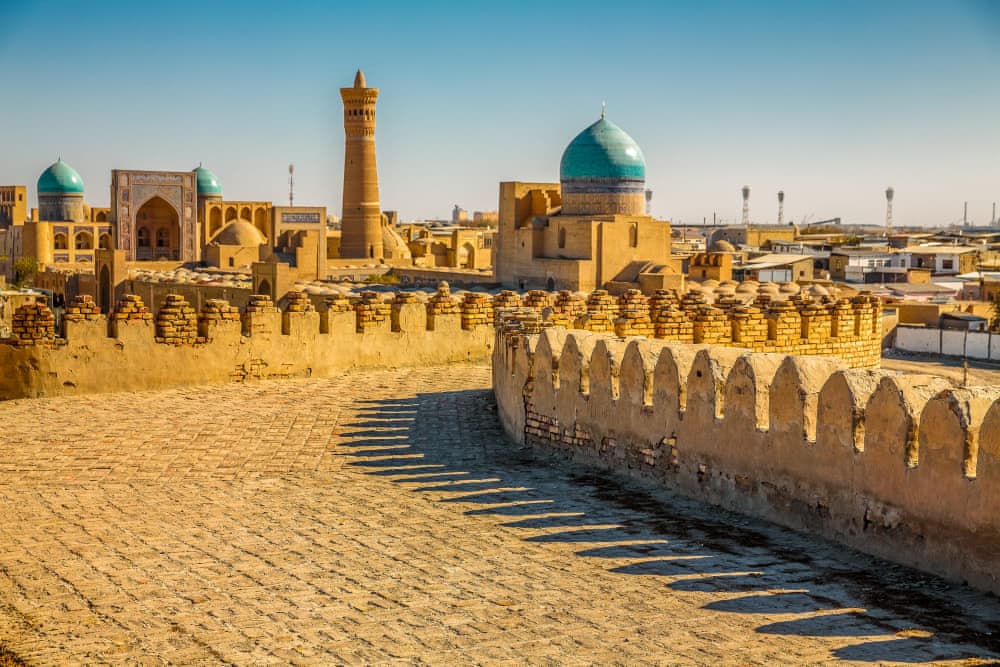 View through the fortress wall of the old town with minarets and madrasas of Bukhara
